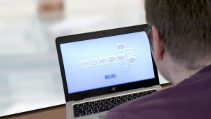 Man using Rehacom software on a computer