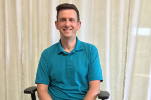 Nick Sobieraj , our speech and language therapist at Nottingham Brain Injury Rehabilitation Centre, smiling at the camera.